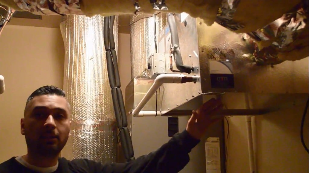 M&M Cellar Systems HVAC team inspects a wine cellar cooling unit with refrigerant leak. 