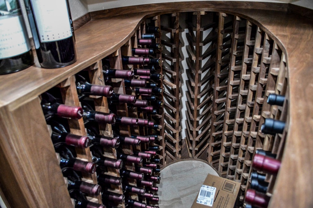 A look inside the wine cellar allows us to see spaces that can now be used for wine storage instead of holding the cooling unit. This makes the flow of the wine room more smooth, and increases the bottle capacity.